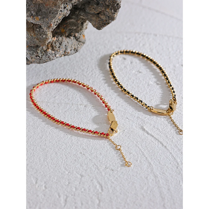 bracelet-femme-elégance-en-fil-noire-rouge-dorées